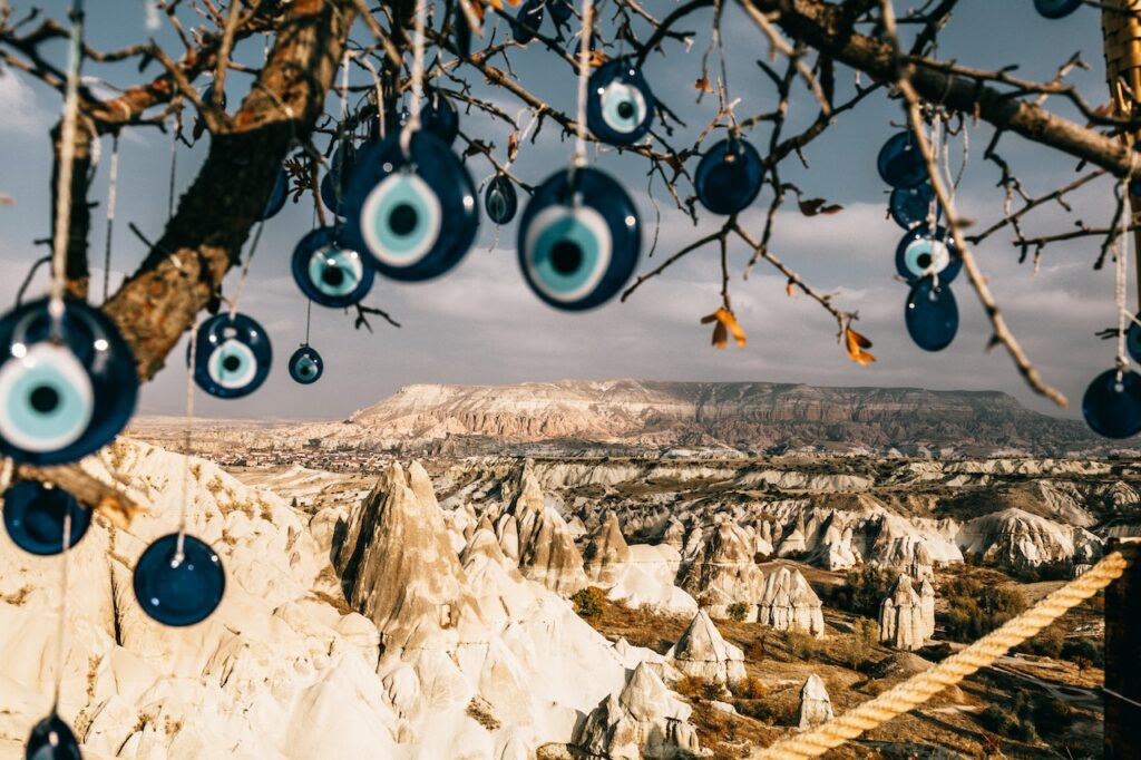 Photo by Meruyert Gonullu: https://www.pexels.com/photo/nazar-amulets-on-tree-branches-near-stony-formations-in-cappadocia-6243268/