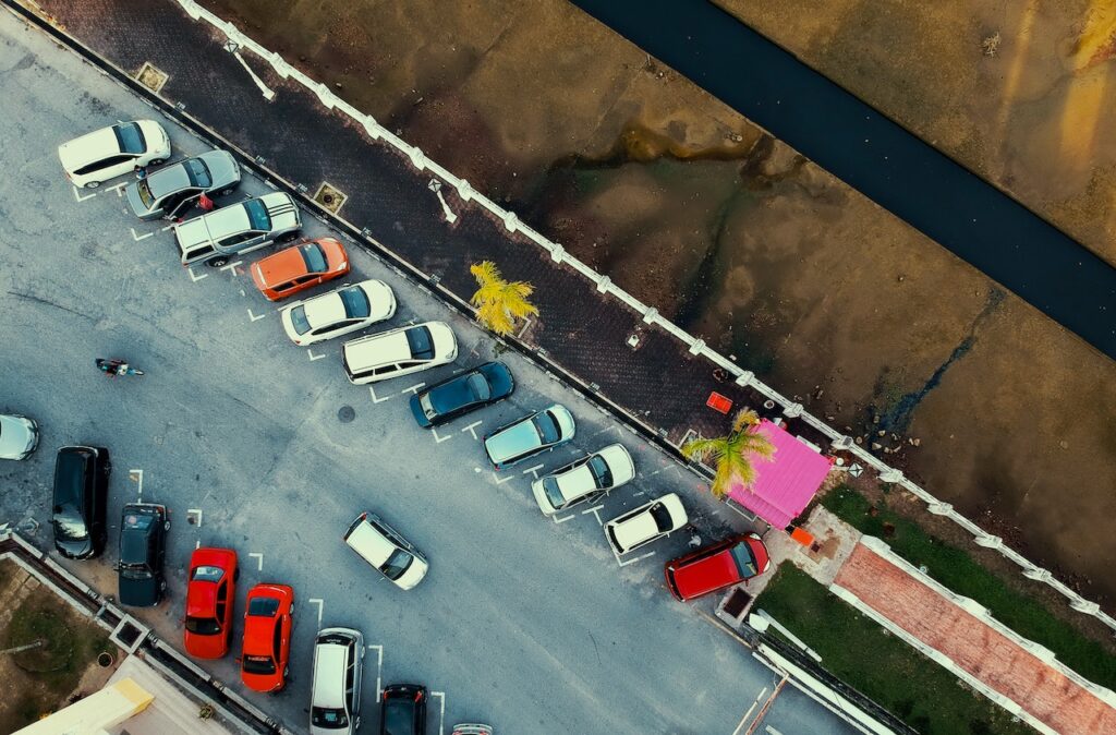 Photo by Pok Rie: https://www.pexels.com/photo/bird-s-eye-view-of-parked-cars-1004409/